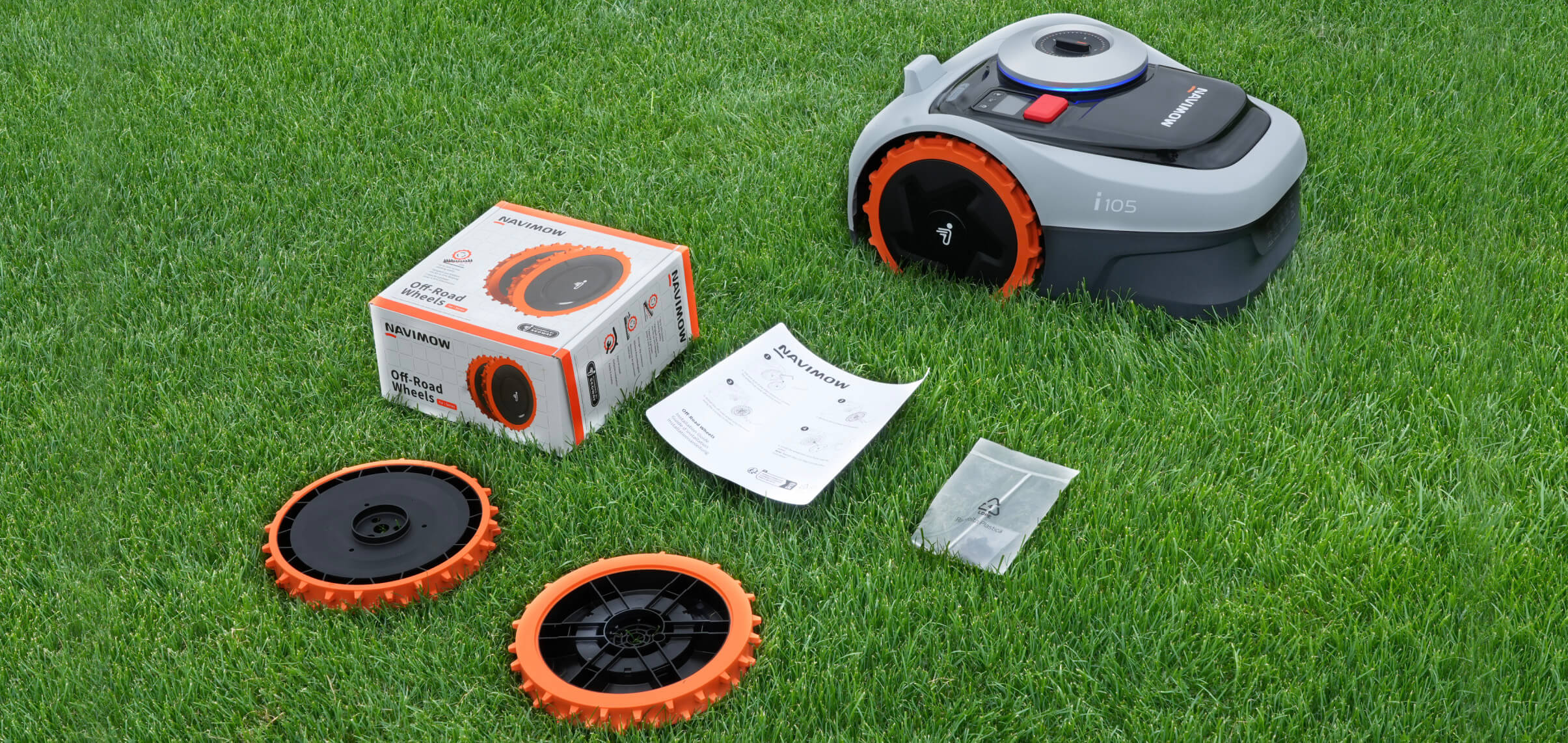 Navimow i105 robot lawn mower with wheels and boxed kit.